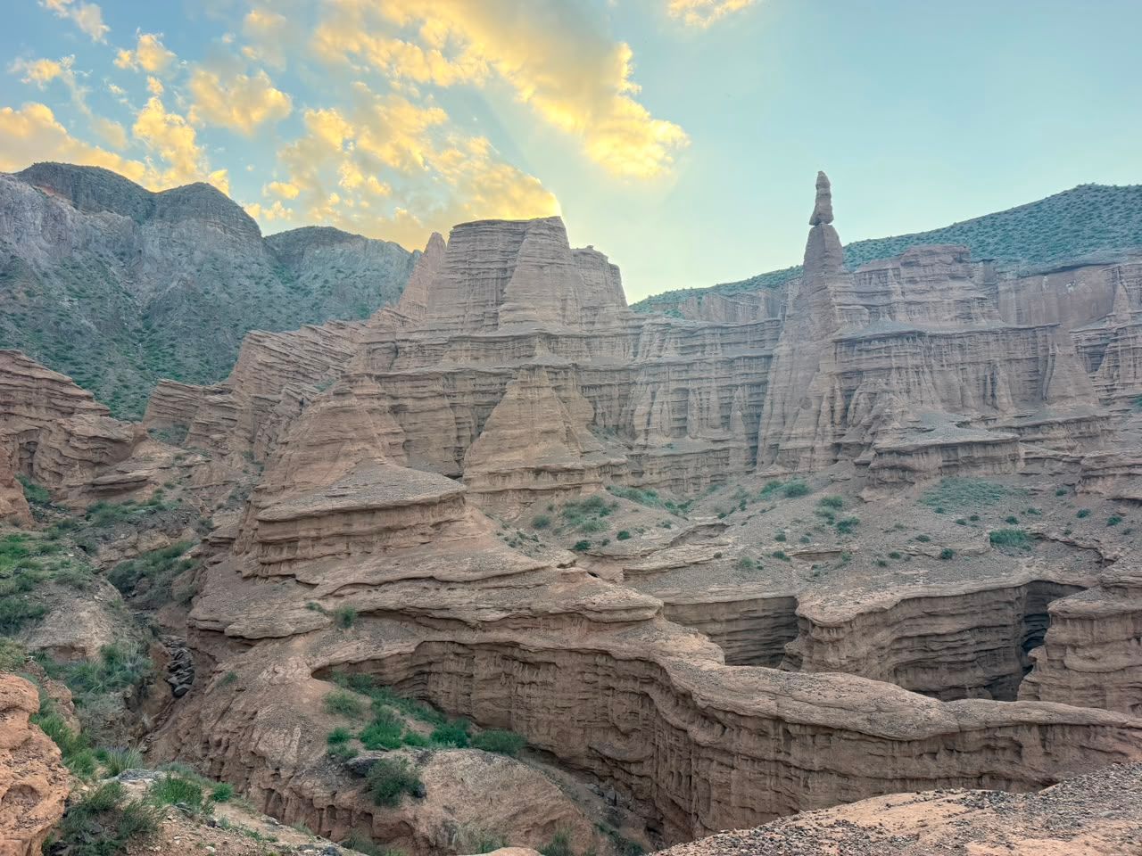 The eroded sandstone pinnacles of Skazka (Fairytale) Canyon in warm evening light.
