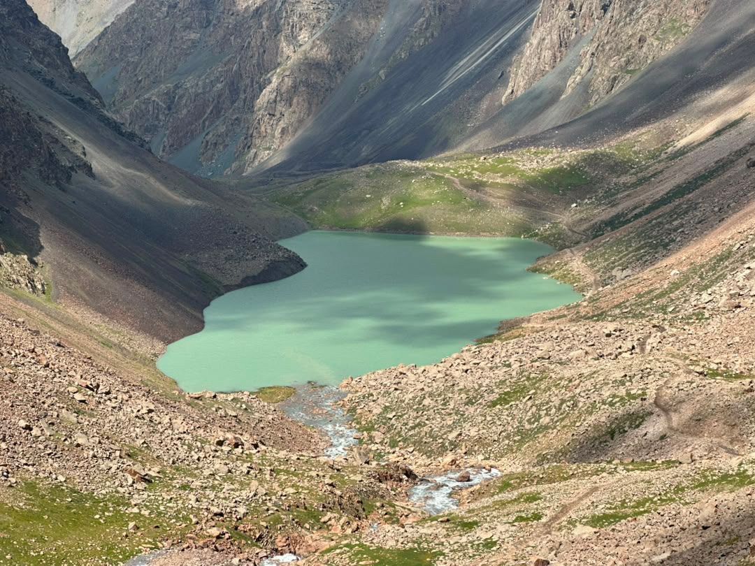 Turquoise alpine lake in a steep rocky cirque.