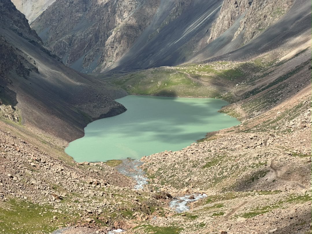 Turquoise alpine lake in a steep rocky cirque.